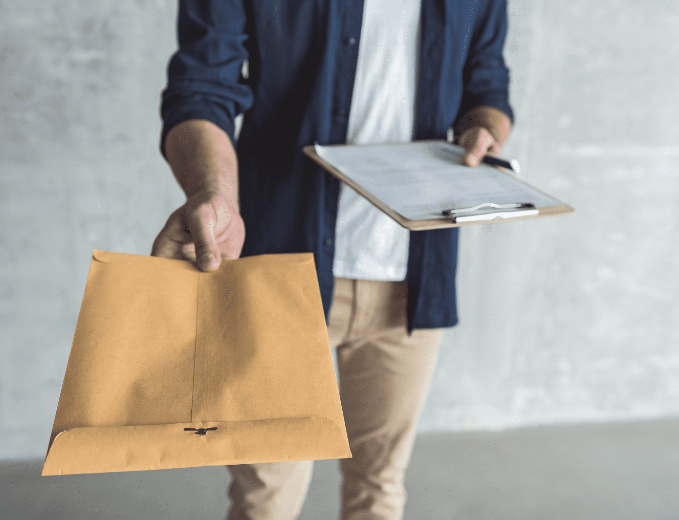 Person handing over envelope and clipboard.