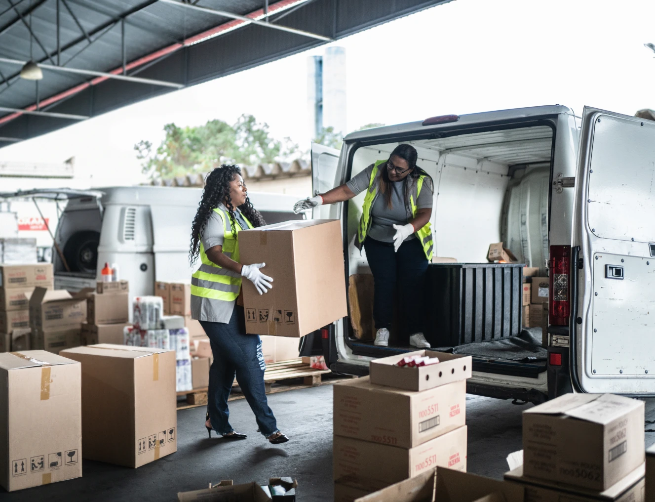 Workers loading boxes into delivery van.
